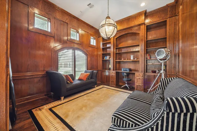 a livingroom with furniture and a floor to ceiling window