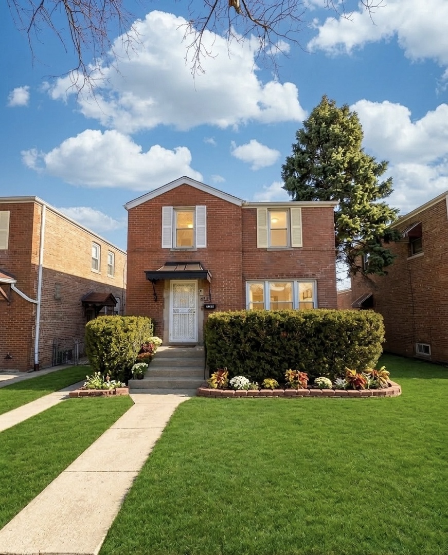 3338 West 83rd Place Chicago, IL 60652 - Photo 1 of 26 a front view of a house with a garden