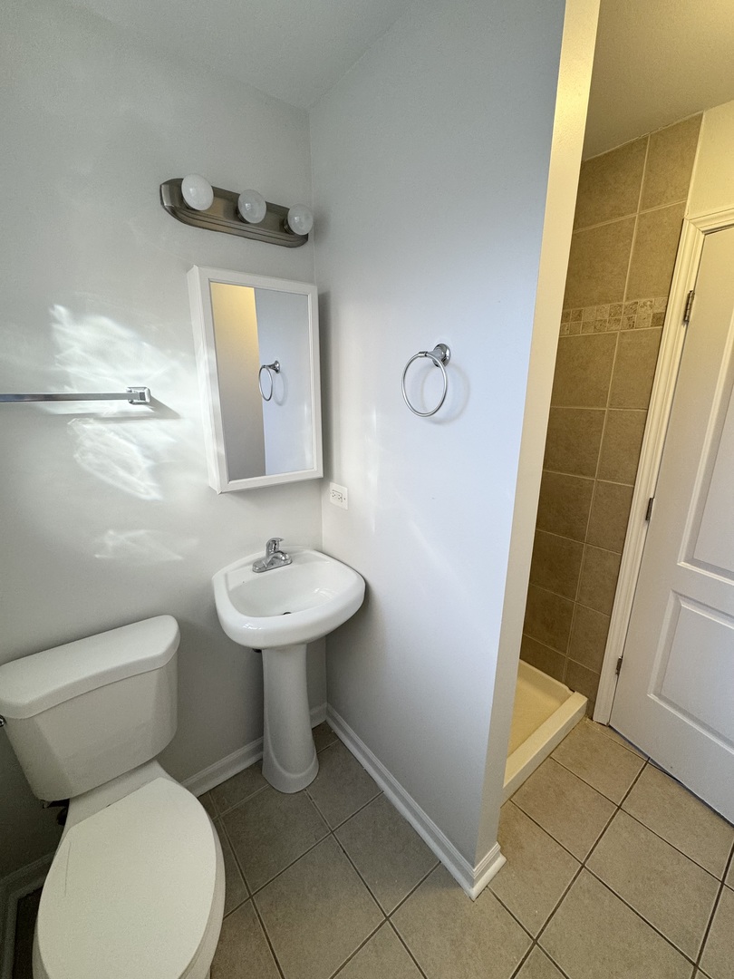 3338 West 83rd Place Chicago, IL 60652 - Photo 11 of 26 a bathroom with a toilet sink and mirror