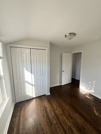 a view of a livingroom with wooden floor and window