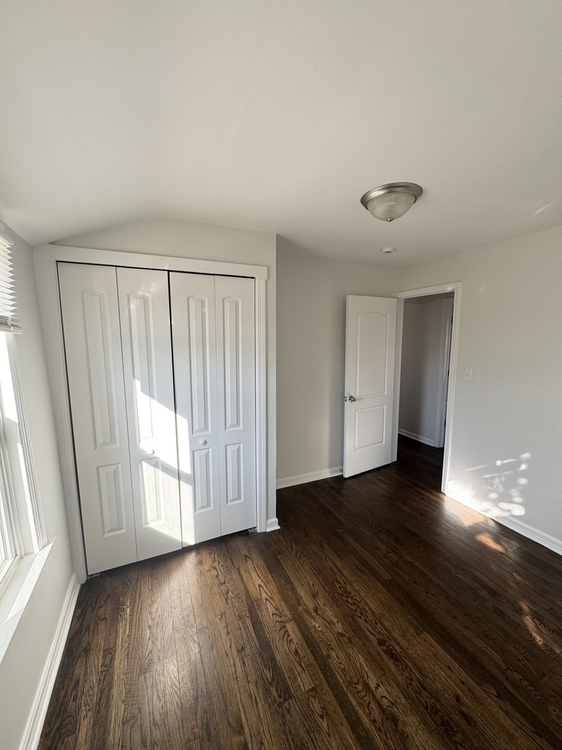 3338 West 83rd Place Chicago, IL 60652 - Photo 15 of 26 a view of a livingroom with wooden floor and window
