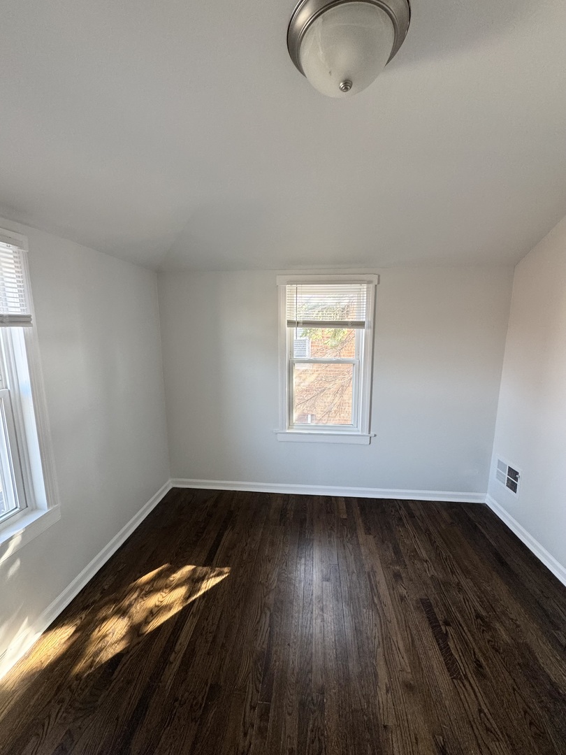3338 West 83rd Place Chicago, IL 60652 - Photo 16 of 26 a view of room with hardwood floor and window