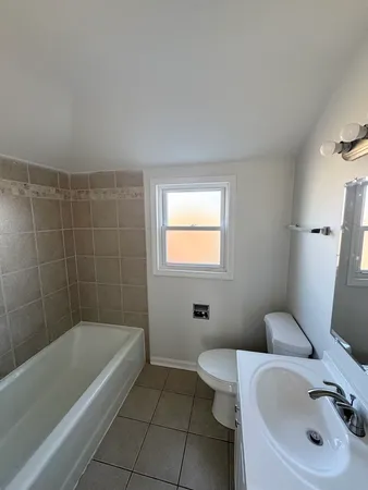 a bathroom with a sink a toilet and bathtub
