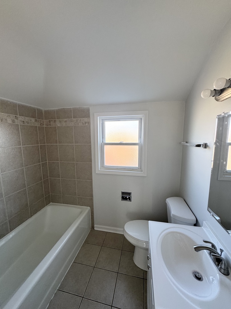 3338 West 83rd Place Chicago, IL 60652 - Photo 18 of 26 a bathroom with a sink a toilet and bathtub
