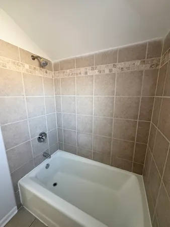 a bathroom with a bathtub and shower