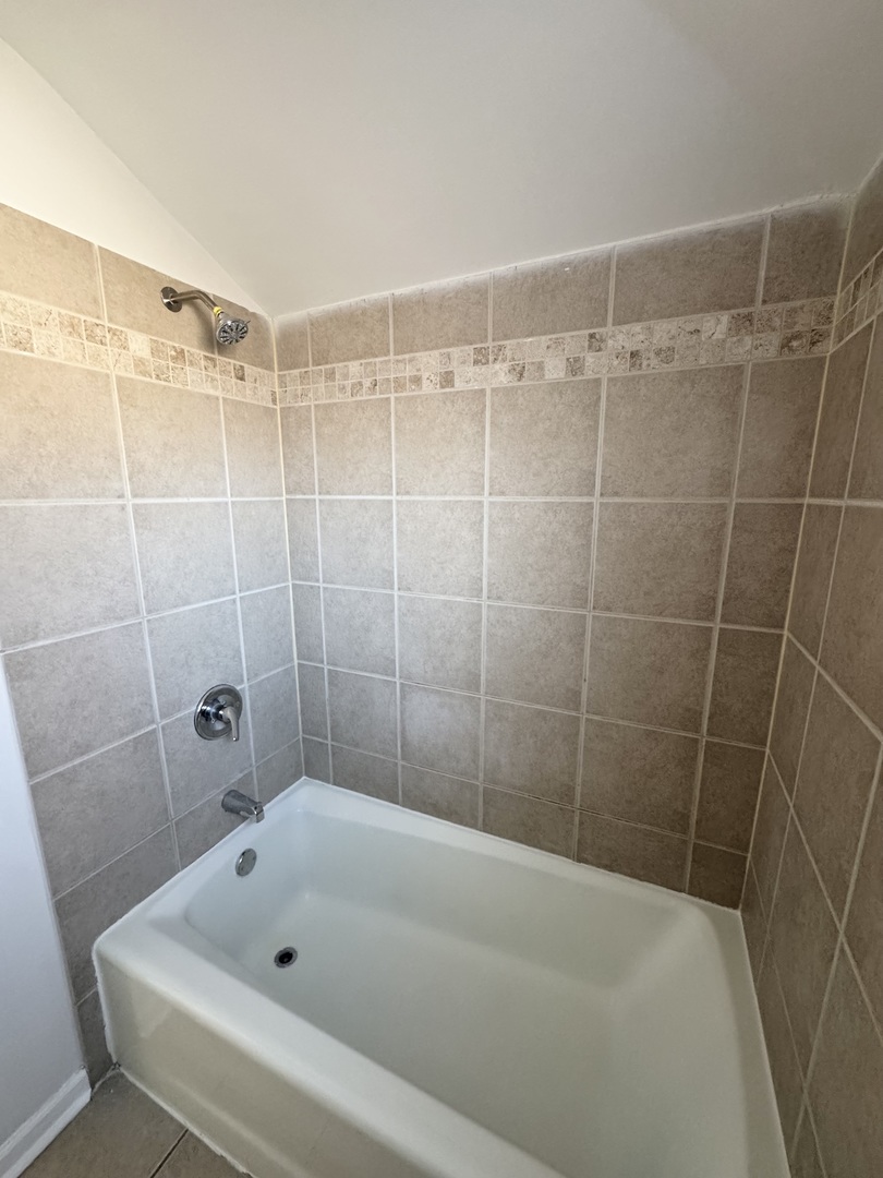 3338 West 83rd Place Chicago, IL 60652 - Photo 19 of 26 a bathroom with a bathtub and shower