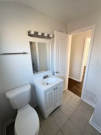 a bathroom with a sink a toilet and mirror