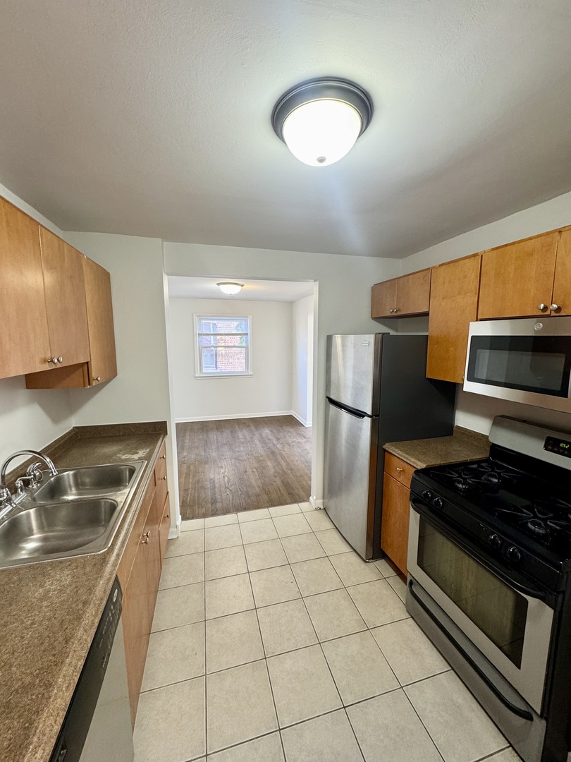 3338 West 83rd Place Chicago, IL 60652 - Photo 5 of 26 a kitchen with a sink a stove and refrigerator