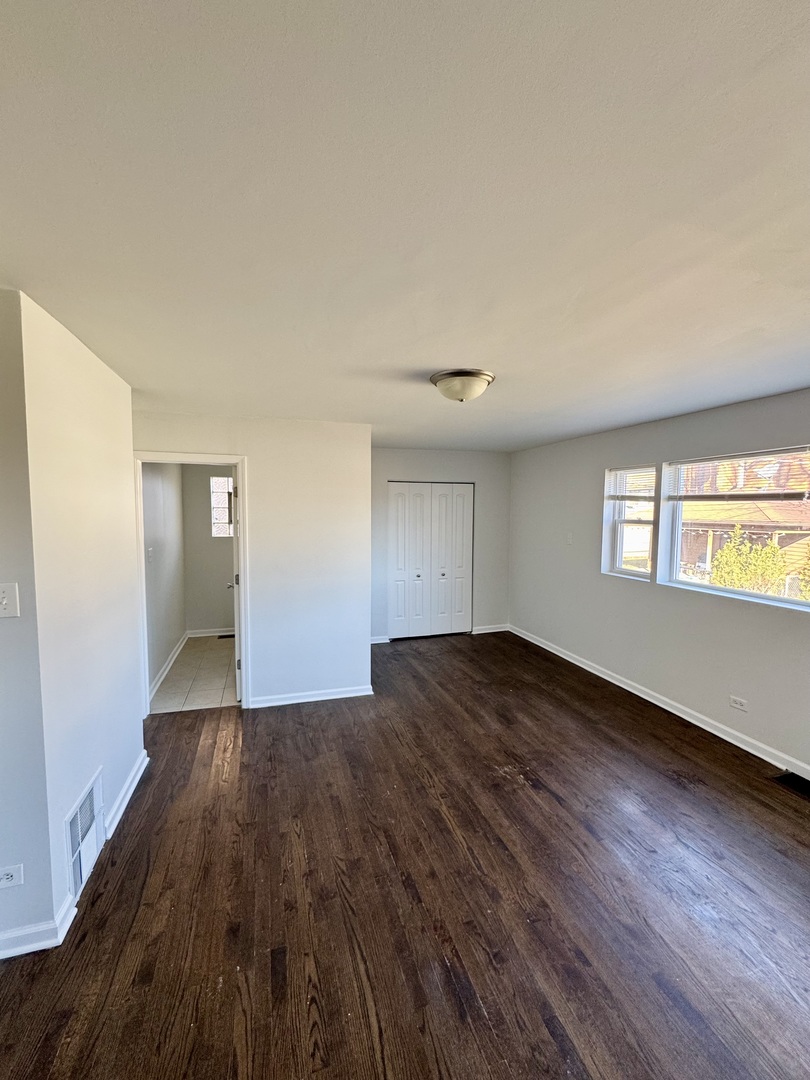 3338 West 83rd Place Chicago, IL 60652 - Photo 7 of 26 a view of empty room with window and wooden floor