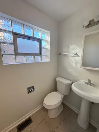 a white toilet sitting next to a bathroom sink