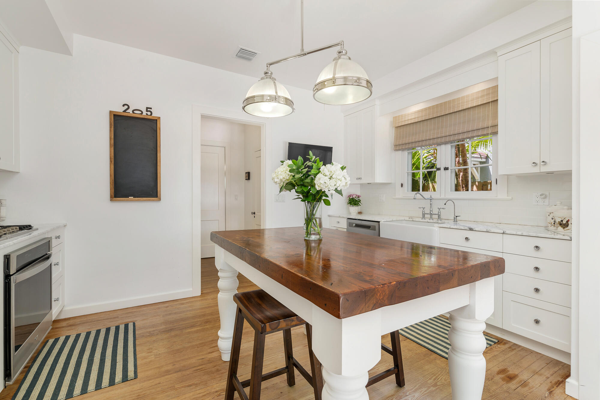 205 Westminster Road West Palm Beach, FL 33405 - Photo 14 of 37 a kitchen with a table chairs and microwave
