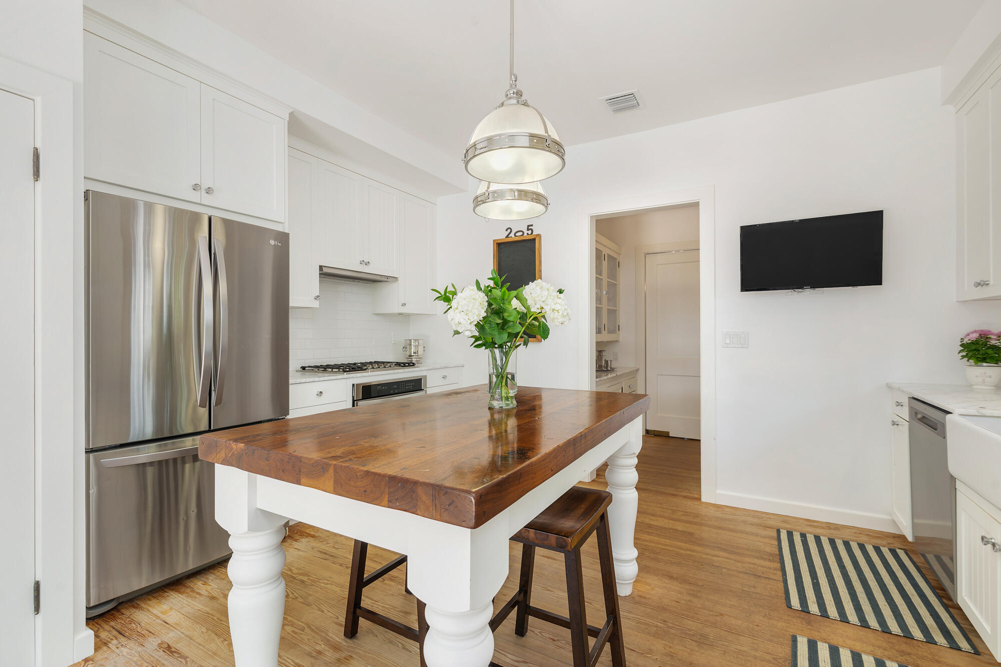 205 Westminster Road West Palm Beach, FL 33405 - Photo 15 of 37 a kitchen with stainless steel appliances granite countertop a refrigerator a microwave a stove and a dining table