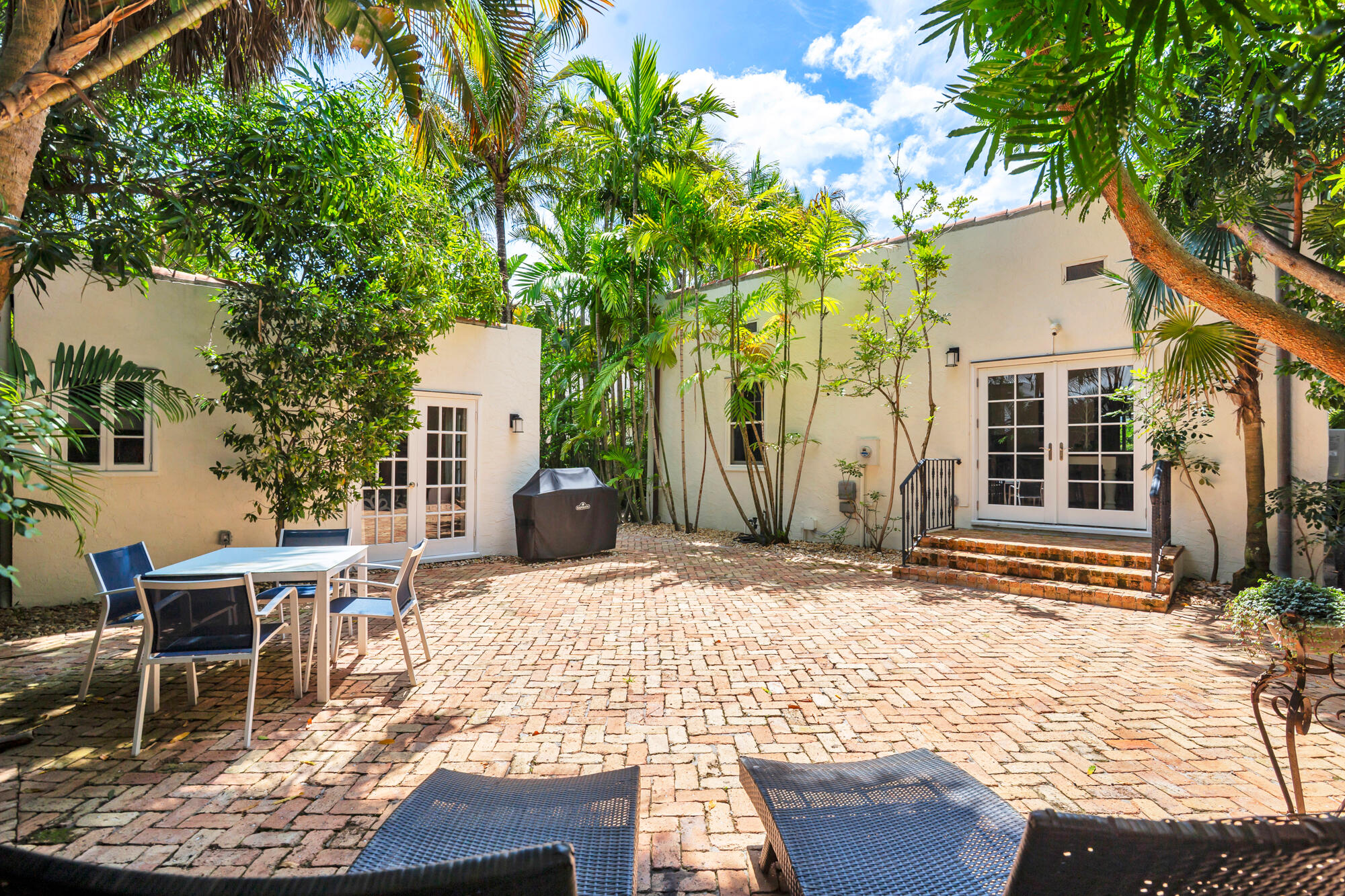 205 Westminster Road West Palm Beach, FL 33405 - Photo 22 of 37 a patio with table and chairs and potted plants