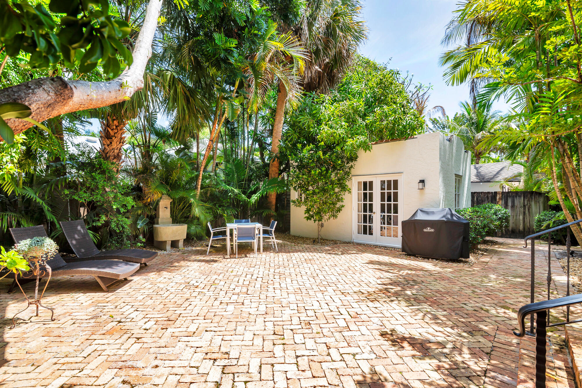 205 Westminster Road West Palm Beach, FL 33405 - Photo 23 of 37 a backyard of a house with table and chairs