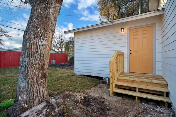 a view of a backyard with a tree