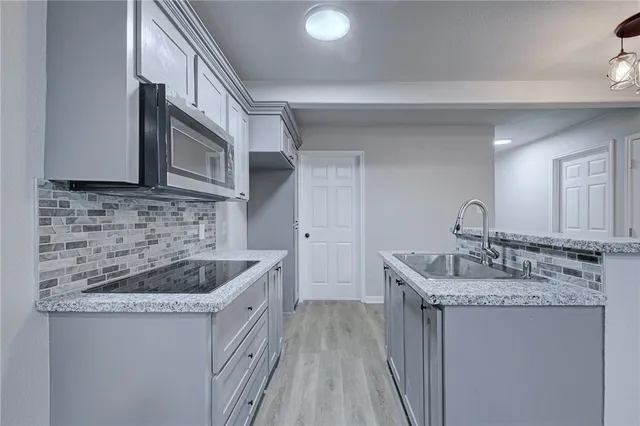 a kitchen with a sink and cabinets