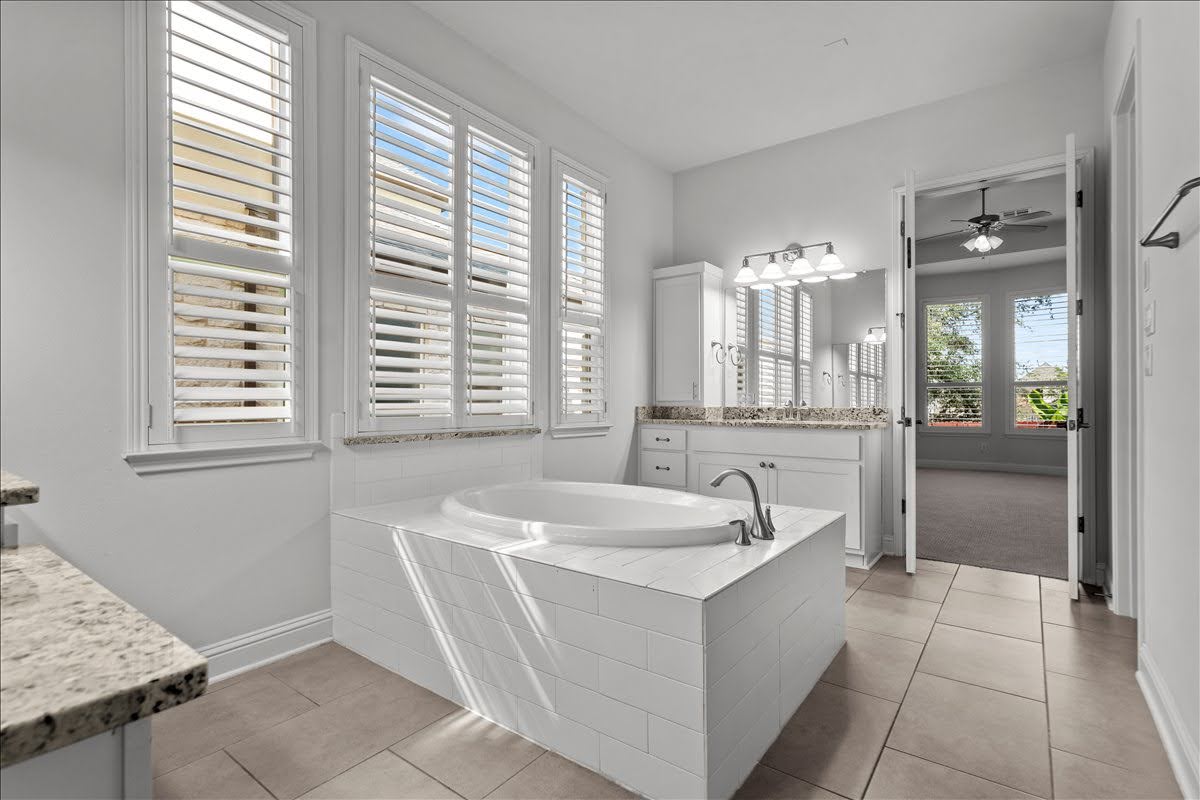 4108 Bison Bend, Unit FOR RENT Cedar Park, TX 78613 - Photo 24 of 36 Indulge in a tranquil bathing experience within this bathroom, featuring a deep soaking tub and dual vanities.