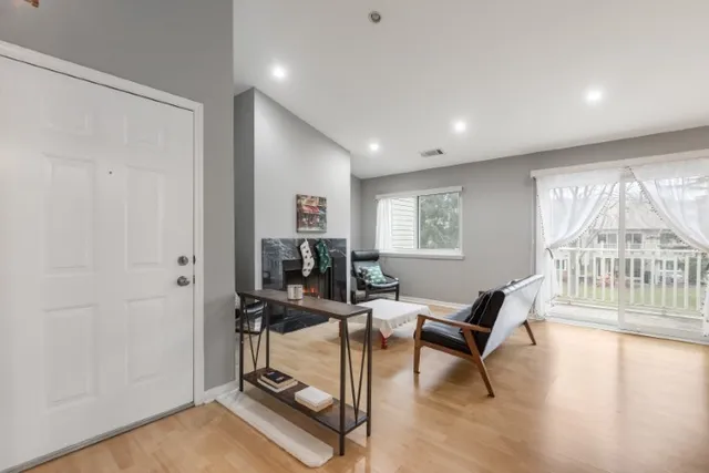 a view of a livingroom with a window and lounge chair