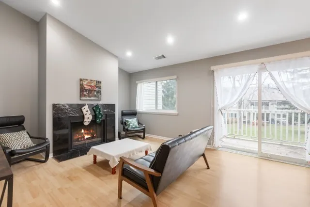 a living room with furniture a flat screen tv and a fireplace