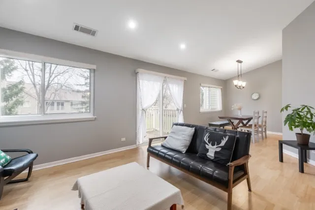 a living room with furniture and a potted plant