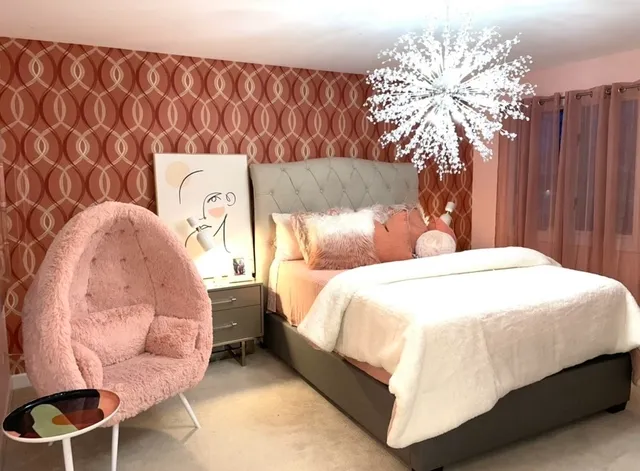 a bedroom with a bed and a chandelier