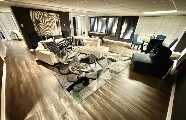 a living room with furniture and a wooden floor