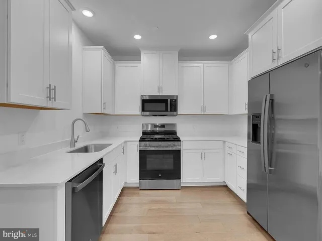a kitchen with a sink stove and refrigerator