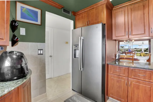 a kitchen with stainless steel appliances granite countertop a sink and a stove
