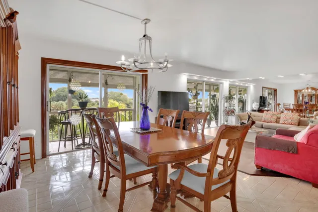 a living room with furniture kitchen view and a large window