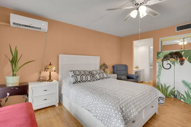 a bedroom with a large bed and a chandelier