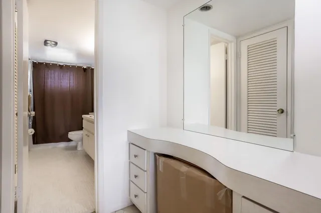 a bedroom with a bed potted plant and a large mirror