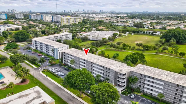 an aerial view of a house with a garden and lake view