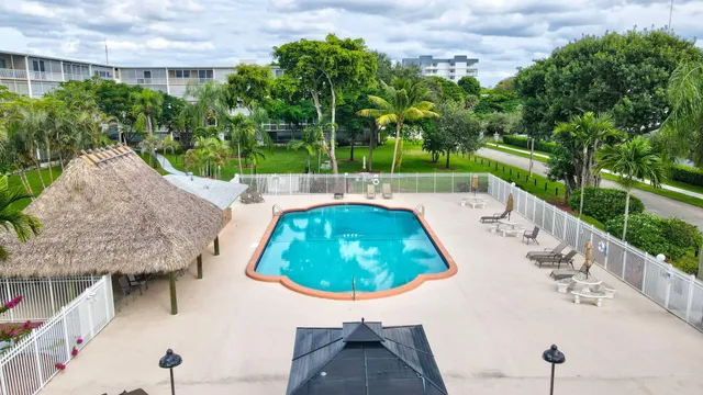 a swimming pool with outdoor seating and yard