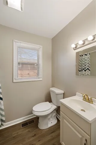 a bathroom with a sink toilet and a mirror