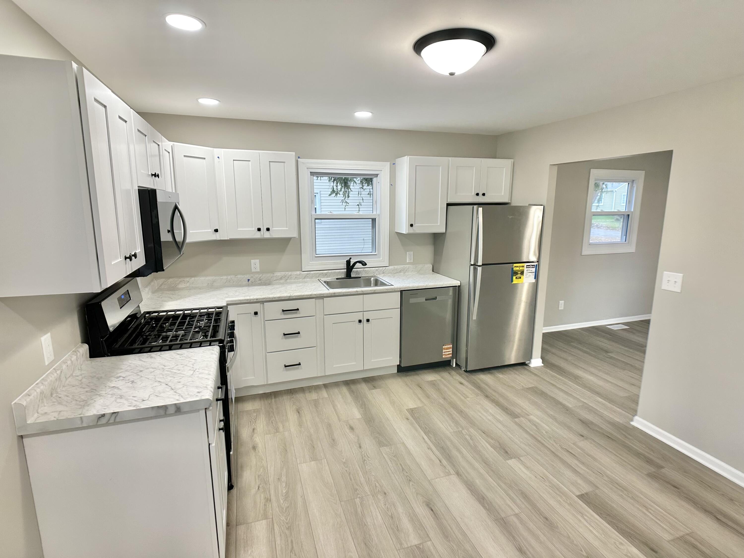 306 Maple Street Crown Point, IN 46307 - Photo 4 of 21 a kitchen with a refrigerator a sink and dishwasher
