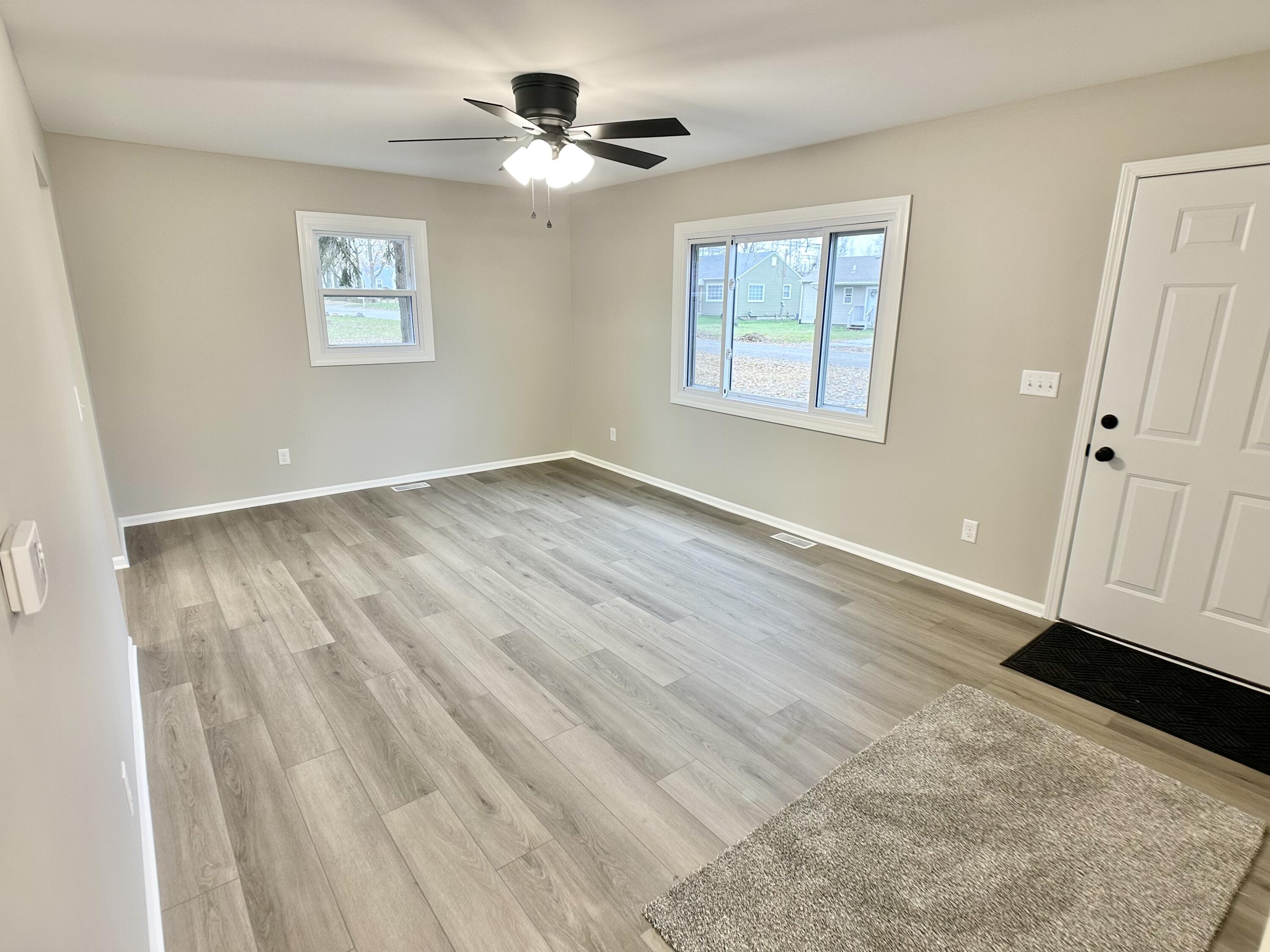 306 Maple Street Crown Point, IN 46307 - Photo 6 of 21 a view of an empty room with a window and wooden floor