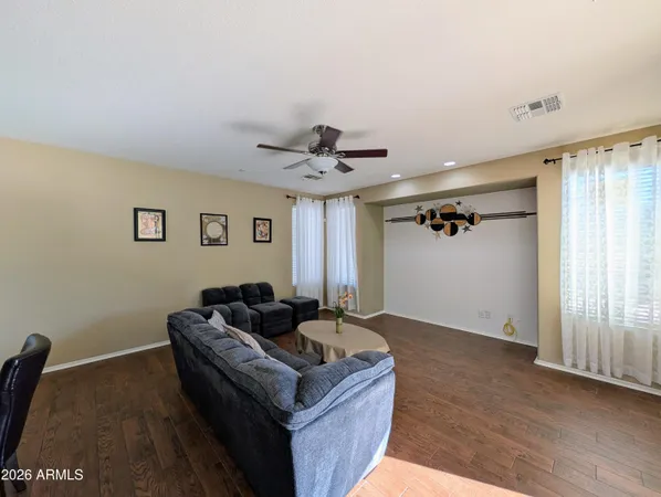 a view of a hallway view with wooden floor and living room