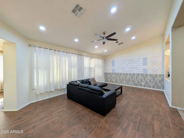 a view of a livingroom with a ceiling fan and wooden floor