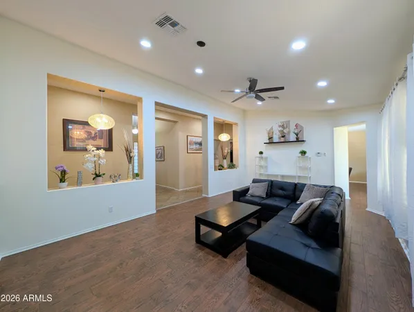a view of a hallway with wooden floor and cabinet