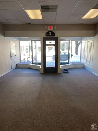 a view of a room with window and a ceiling fan