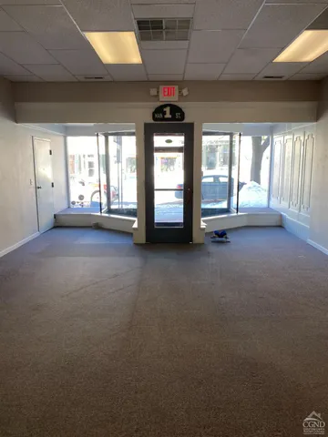 a view of a room with window and a ceiling fan
