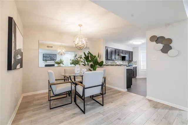 a living room with furniture wooden floor and kitchen view