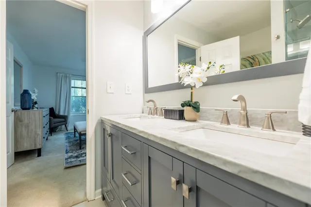 a bathroom with a granite countertop sink and a mirror