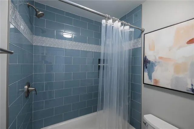 a bathroom with a shower and a toilet