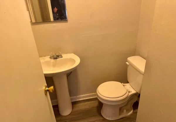 a bathroom with a sink a toilet and a mirror