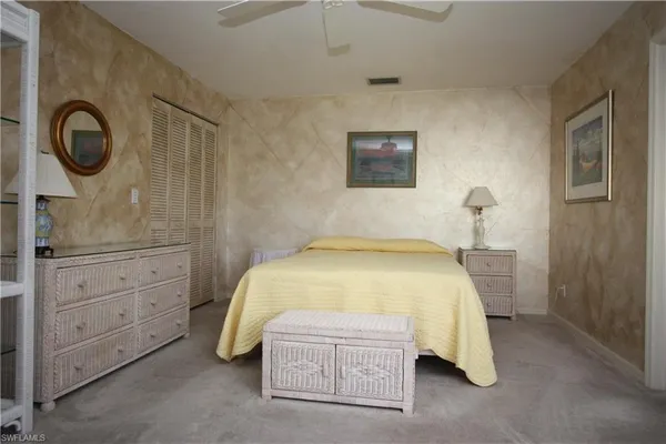 a bedroom with a bed and a dresser