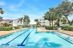 a view of a house with swimming pool and sitting area