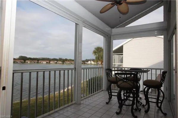a view of a chairs and table in patio with wooden fence