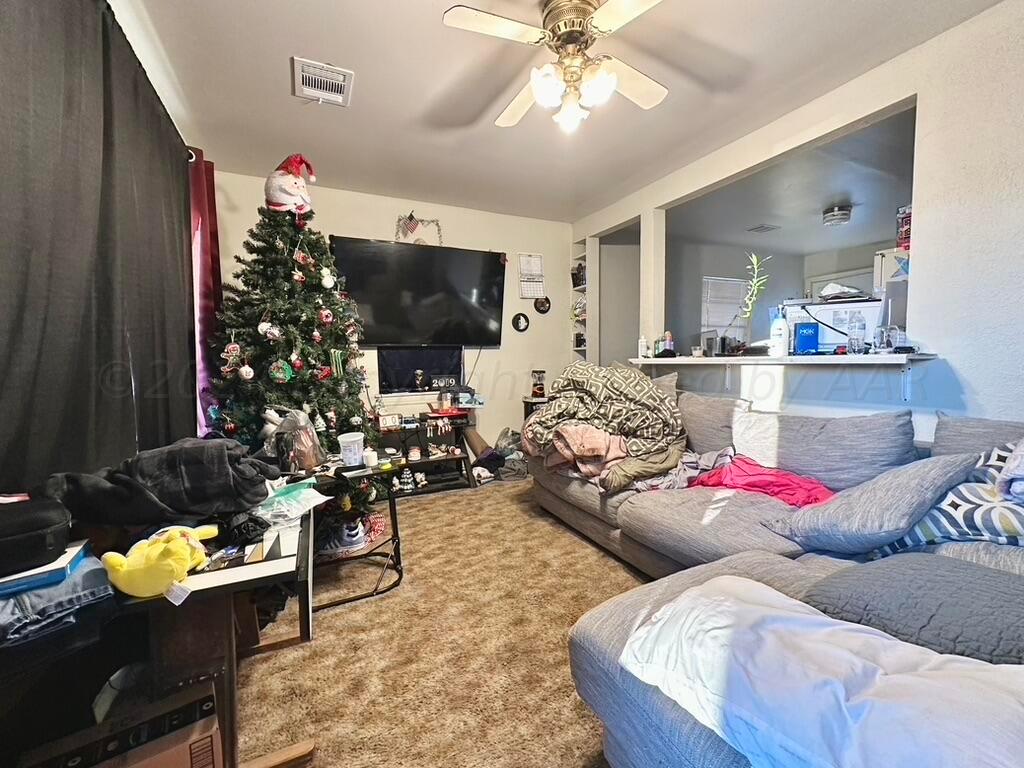 4611 South Ong Street Amarillo, TX 79110 - Photo 3 of 11 a living room with furniture and a flat screen tv