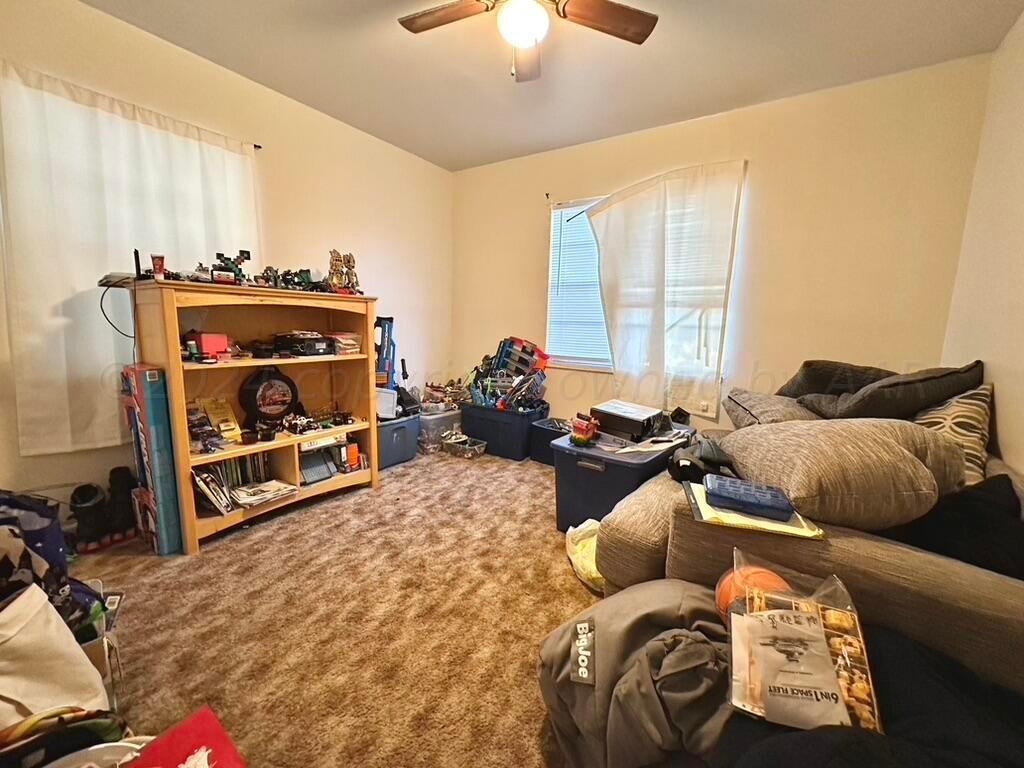 4611 South Ong Street Amarillo, TX 79110 - Photo 6 of 11 a living room with furniture and a chandelier